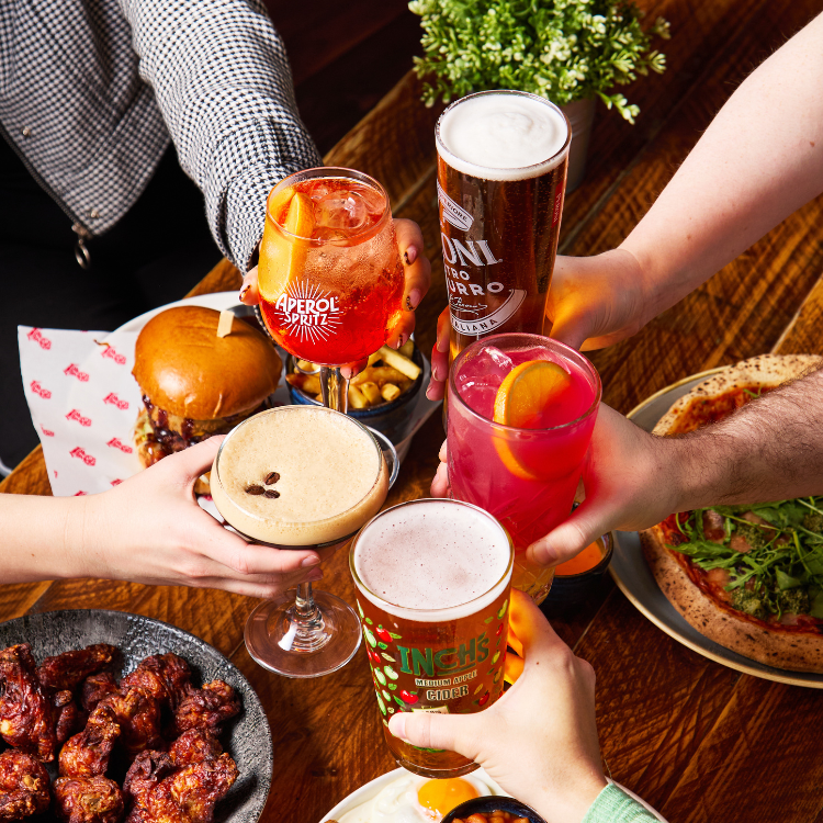 People cheersing drinks at bottomless brunch