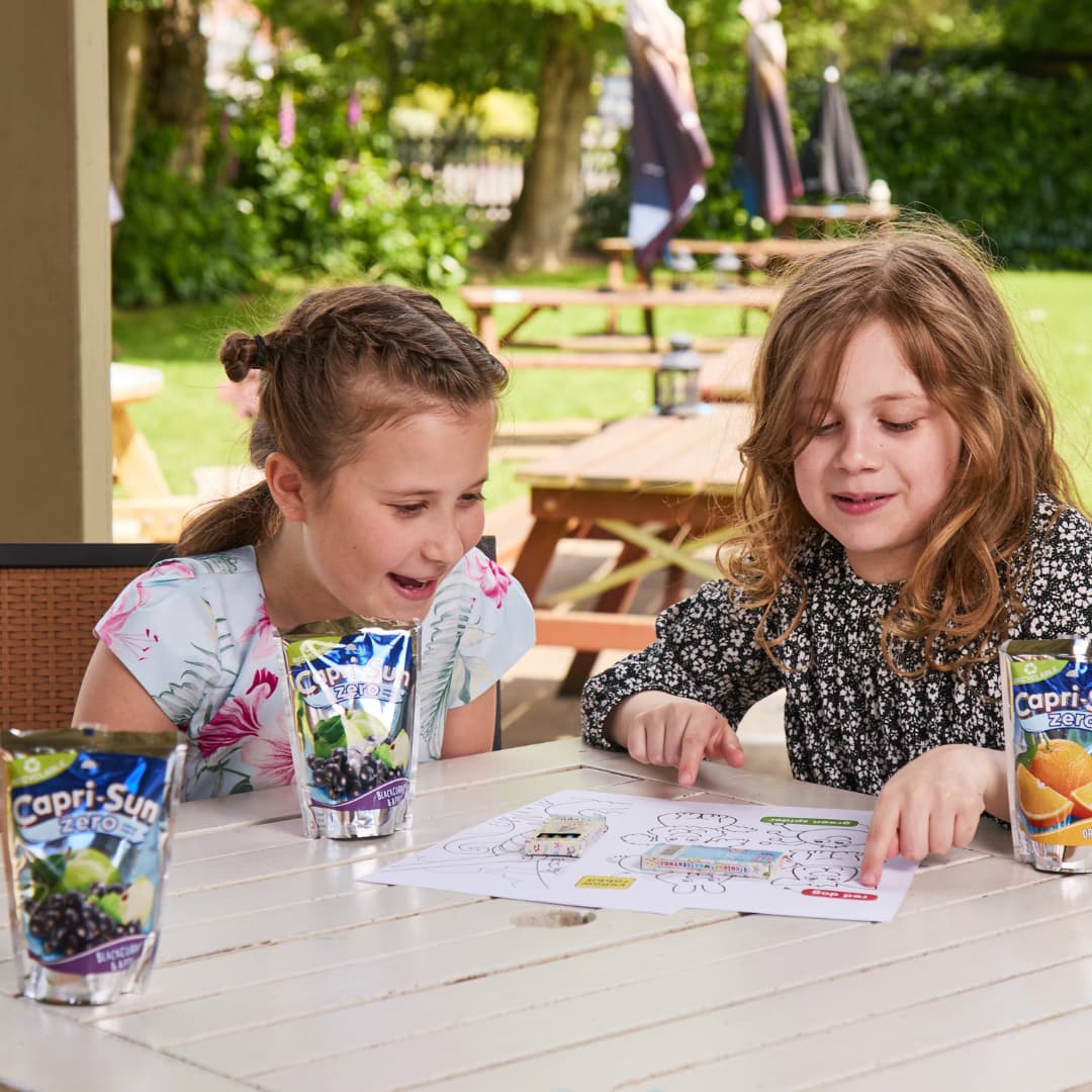 two children sitting outside