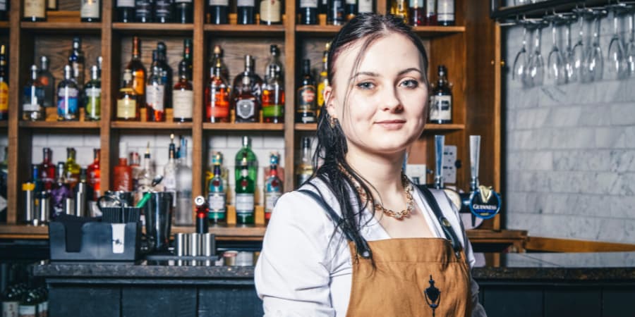 Team Member from our Chapter Collection bars smiling at the camera