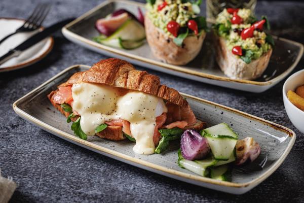 Forge eggs royale with two poached eggs, Cheddar sauce, smoked salmon and watercress, served in baked croissant